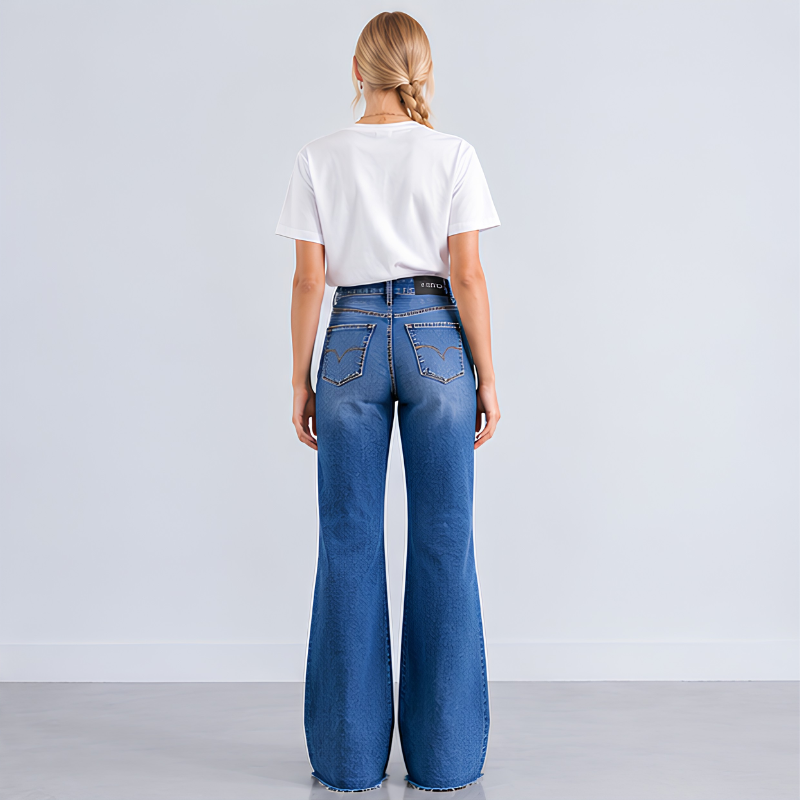 A woman viewed from behind wearing a white short-sleeve t-shirt and high-waisted, wide-leg blue denim jeans with a heart-shaped pocket detail on the back.